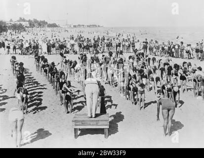 Mass exercise in the open air at Miami . Mass exercise in the sunshine , on the beach at Miami Florida , where several hundred bathers perform morning exercise under an instructor on the beach . Mass exercise on the beach at Miami Florida . 1 February 1932 Stock Photo