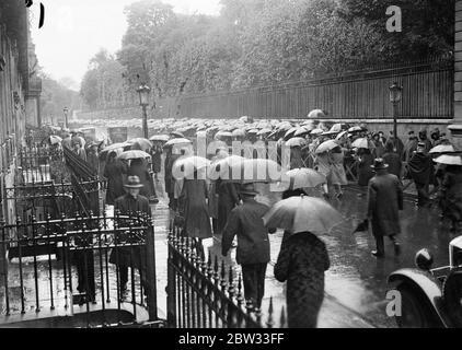 Crowds wait hours in the rain to pay last honours to murdered French president . Crowds lined up for hours waiting to pay their last respect to the late President Doumer of France who was assassinated by a Russian doctor a Russian doctor while attending a book exhibition in Paris , as he lay in state in the Elysee Palace . A view of the crowd waiting to enter the Elysee Palace in Paris to view the body . 9 May 1932 Stock Photo