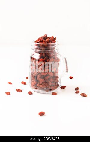 Super brain food dry Goji berry in glass jar isolated on white background with copy space Stock Photo