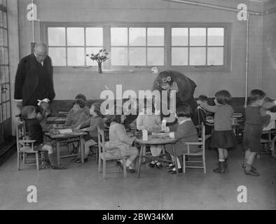 Duchess of York among the babies . The Duchess of York opened the new building of the City of Westminster Health Society maternity and child welfare centre at Marsham Street , Westminster , London . The Duchess of York with some of the children on the roof top nursery of the new welfare centre . 8 March 1932 Stock Photo