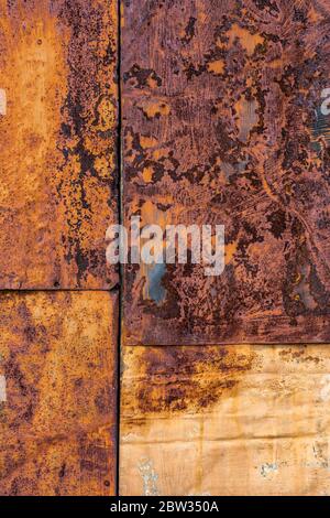 Rusted flat composite nailed metal sheets surface background and texture. Stock Photo