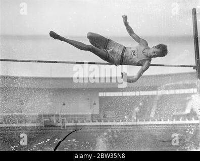 Oxford athletes train for meeting with Cambridge at White City . The Oxford team who are to meet Cambridge in the inter varsity sports at the White City on Saturday , trained at the White City , London . C S Stanwood of Wellesley Hills , Mass , USA , in fine action in the high jump , during practice . 13 March 1933 Stock Photo