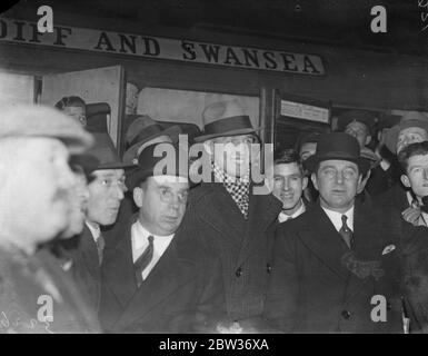 Enormous crowd welcomes Jack Petersen on arrival in London from Cardiff for fight with Len Harvey . An enormous crowd gathered at Paddington Station , London to welcome Jack Petersen on his arrival from Cardiff for his fight with Len Harvey at the Royal Albert Hall , London , tomoorow night . Photo shows ; Jack Petersen ( centre ) surrounded by admirers on arrival at Paddington . 29 November 1933 Stock Photo