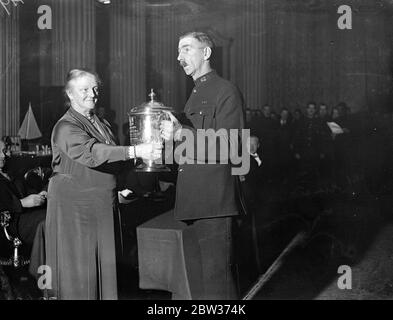 Lord Mayor presents prizes to police athletes . The Lord Mayor of London , Sir Charles H Collett , presented awards won by members of the City of London Police Athletic Club , at the Mansion House . Photo shows ; The Lady Mayoress presenting the Colonel Matthey Cup for pistol shooting to Constable Nash , who also won the Club Rifle Shooting Championship . 13 December 1933 Stock Photo