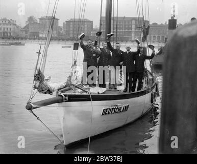 A sailing yacht manned by a crew of six young Germans has arrived at Southampton on the completion of a stage of a 30 , 000 miles voyage round the world , which is expected to occupy two and a half or three years . the skipper is Captain H Crosche , the youngest Master Mariner in Germany . He is only 25 . The purpose of the trip is said to be to visit German people in all countries and to acquaint them with the position of Germany at the present time . After calling at 50 ports , the vessell will return to Germany from New York . Photo shows , the crew cheering aboard their yacht at Southampto Stock Photo