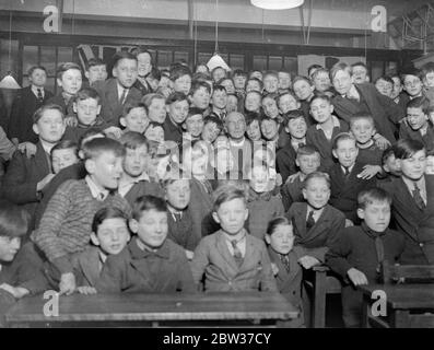 Bishop of London among schoolboys . The bIshop of London opened the new Hall of the St George the Martyr Schools , in Old Gloucester Road , London . Photo shows , the Bishop of London among the schoolboys after opening the new hall . 27 January 1932 Stock Photo