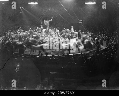 Six thousand schoolchildren watch rehearsal of Olympia circus . Six thousand school children watched the dress rehearsal of the Olympia christmas circus , at Olympia , London . Photo shows ; Circus horses in the circus ring . 21 December 1933 Stock Photo