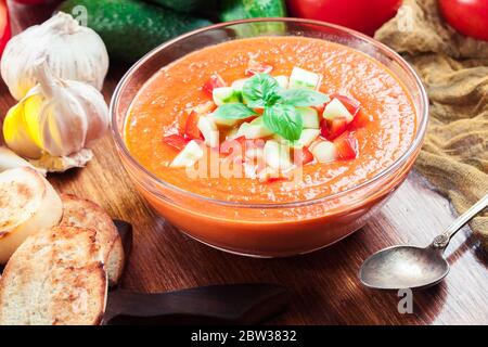 Spicy homemade gazpacho soup served with jamon ham. Traditional spanish dish Stock Photo