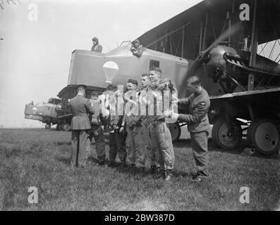 RAF parachute test section at work . A demonstration was given at the Royal Air Force parachute section at Henlow Aerodrome , Bedfordshire , of the work and training of parachutists . Testing parachutes is one of the items open to inspection by the public on Empire Air Day May 24 . Photo shows , inspection of parachute crews before descent during the demonstration in front of their Vickers 'Virginia' parachute training aircraft . 10 May 1934 Stock Photo