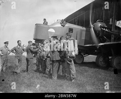 RAF parachute test section at work . A demonstration was given at the Royal Air Force parachute section at Henlow Aerodrome , Bedfordshire , of the work and training of parachutists . Testing parachutes is one of the items open to inspection by the public on Empire Air Day May 24 . Photo shows , inspection of parachute crews before descent during the demonstration in front of their Vickers 'Virginia' parachute training aircraft . 10 May 1934 Stock Photo