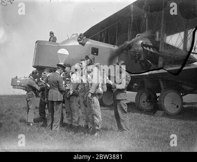 RAF parachute test section at work . A demonstration was given at the Royal Air Force parachute section at Henlow Aerodrome , Bedfordshire , of the work and training of parachutists . Testing parachutes is one of the items open to inspection by the public on Empire Air Day May 24 . Photo shows , inspection of parachute crews before descent during the demonstration in front of their Vickers 'Virginia' parachute training aircraft . 10 May 1934 Stock Photo