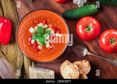 Spicy homemade gazpacho soup served with jamon ham. Traditional spanish dish Stock Photo