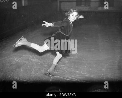 An expert on the ice at seven . Miss Mary Rose Barrington , the seven year old daughter of Mrs Minerva Barrington , captain of the London Lambs Ice Hockey Team , is already a very promising skater . She started to skate almost as soon as she could walk and has already won her bronze medal . Photo shows ; Mary Rose Barrington , aged 7 , practising a figure on the Grosvenor House Ice Rink , London . 13 January 1934 30s, 30's, 1930s, 1930's, thirties, nineteen thirties Stock Photo