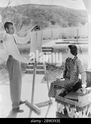 Gary Cooper tests his skill with the pencil on a society girl as his wife looks on . Gary Cooper , the American film actor , who was recently married in New York to the former Sandra Shaw , a well known society girl , trying out his artistic skill in the garden of his Hollywood home as his wife looks on . 5 April 1934 30s, 30's, 1930s, 1930's, thirties, nineteen thirties Stock Photo