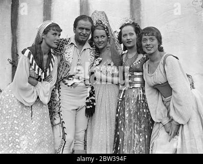 Douglas Fairbanks starts work on his new British film . Production of Douglas Fairbanks ' s new film ' The Private Life of Don Juan ' has been started at the Imperial Film Productions studios . Merle Oberon and Benita Hume are also in the cast . Photo shows , Douglas Fairbanks and Merle Oberon ( 2nd from right ) with other members of the cast . 5 April 1934 30s, 30's, 1930s, 1930's, thirties, nineteen thirties Stock Photo