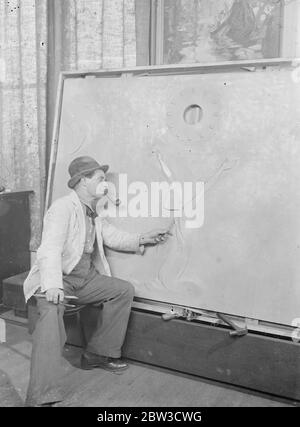Artist shuts himself away for two years to perfect new style . Completing big panel for  Queen Mary  . Mr C Rebel Stanton working on his panel for the Queen . 29 October 1935 Stock Photo