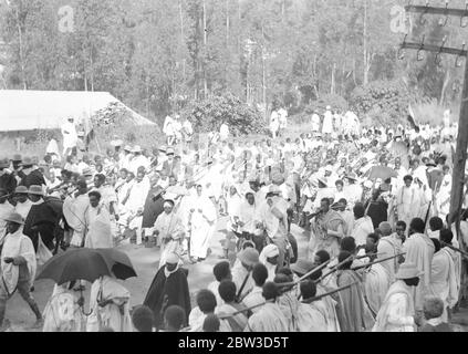 Emperor celebrates in midst of crisis anniversary of coronation . Despite the menace of the Italian invasion the anniversary of the coronation of Emperor Haile Selassie of Abyssinia was celebrated with regal pomp in Addis Ababa . The event was commemorated with a State procession through te town and a great military parade . Thousands of tribesmen led by important chieftains flocked into the capital to pay homage to their ruler and express their loyalty to him in the present crisis . Photo shows , tribesman with rifles in the procession . 15 November 1935 Stock Photo