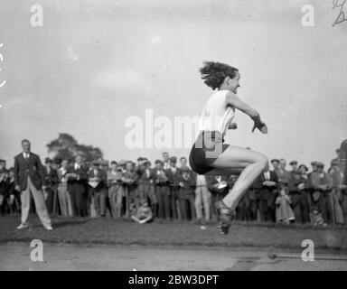 Sitting on air ! . The Middlesex Ladies ' Athletic Club Championships and Handicaps were held in Victoria Park . Photo shows E Raby winning the long jump championship with a leap of 16 ft 9 ins . 8 September 1935 Stock Photo