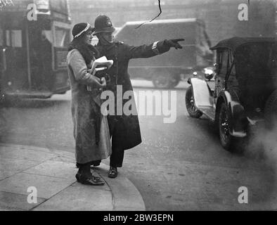 Police teach pedestrians how to cross the road over the crossing in Whitehall , London . 10 January 1935 Stock Photo