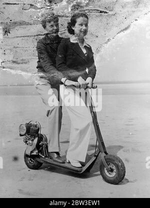 America 's  Lady Lindy  comes down to earth . Amelia Earhart and June Iravis , her film actress pupil , using the new motor scooter at Hollywood airport after June 's first flying lesson . 4 January 1936 Stock Photo