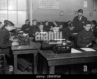 Boys in ' Blind Alley ' jobs saved from becoming derelicts . Messenger boys in the typing class at the Kingsway Institute . 30 January 1935 Stock Photo