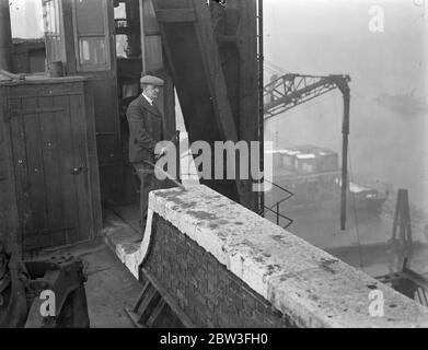 Mr Thompson watches the sky from a cabin on the roof of the power station at Bankside . Mr Walter James Thompson has London ' s queerest job . Every day from eight in the morning till six thirty at night , Mr Thompson sits in a little cabin on the roof of the power station at Bankside watching the sky for clouds and fog . 28 January 1935 Stock Photo