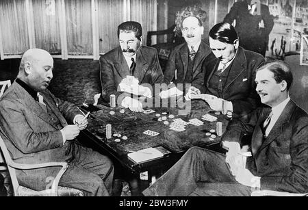 The European situation , as seen through American eyes , is just like a game of poker . In this composite picture which is being published in America as an April Fool 's Day joke , the men who are moulding world history are seen laying their cards on the table . Mussolini ( on left ) appears to enjoy keeping the others wondering , but his subterfuge is lost on Mr Anthony Eden ( right ) who wears an even more expensive smile than usual . Stalin ( second from left ) is content with his  all red  hand , and indeed , the most worried member of the party appears to be Adolf Hitler , whose eyes are Stock Photo
