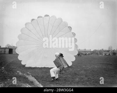 21 year old girl qualifies to become Britain ' s youngest professional parachutist . Miss Josephine Nadin , a 21 year Derby girl , underwent the last part of her Air Ministry test at Broxbourne Aerodrome , Herts to become Britain ' s youngest professional parachutist . Miss Hadin had already successfully accomplished six jumps , and at Broxbourne had four more to do in order to satisfy the Air Ministry officials , as the test comprises ten jumps . Photo shows , Miss Josephine Nadia itesting the parachute before taking off at Broxbourne . 6 April 1936 Stock Photo