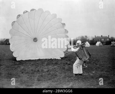 21 year old girl qualifies to become Britain ' s youngest professional parachutist . Miss Josephine Nadin , a 21 year Derby girl , underwent the last part of her Air Ministry test at Broxbourne Aerodrome , Herts to become Britain ' s youngest professional parachutist . Miss Hadin had already successfully accomplished six jumps , and at Broxbourne had four more to do in order to satisfy the Air Ministry officials , as the test comprises ten jumps . Photo shows , Miss Josephine Nadia itesting the parachute before taking off at Broxbourne . 6 April 1936 Stock Photo