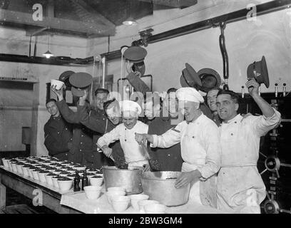 Woolwich barracks troops are making their own christmas pudding . For the first time men of the Royal Artillery at Woolwich Barracks are making their own Christmas puddings instead of buying them from outside . Six hundred men have to be catered for in the messroom and the work of preparing and mixing the puddings has already commenced . Liberal quantities of brand and stout are the most popular ingrediants . Photo shows , cheers for the cook and the puddings at woolwich barracks . 7 December 1935 Stock Photo
