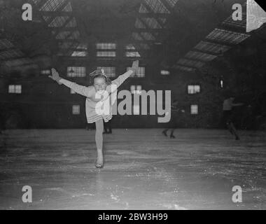 With  wings  extended . 13 year old Norwegian girl practises in London for Olympic Games . Hilland Bjoinshad in a bird like glide on the ice at Millbank , London . 19 November 1935 Stock Photo