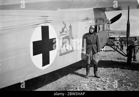 Swedish airman flies victims to safety after bombing of Dolg Red Cross by Italians . These pictures of the bombing by Italian planes of the Swedish Red Cross unit at Dolo as the Abyssinian southern front , were brought to London by air . One Swedish doctor , Dr Gunnard Lundstorm , was killed , together with 50 Abyssinians . All the members of the Swedish staff were injured . The wounded were flown to Addis Ababa by Count von Rosen , a heroic Swedish pilot , who made several journeys between the capital and the scene of the air air raids . Photos shows , Count von Rosen standing beside his plan Stock Photo