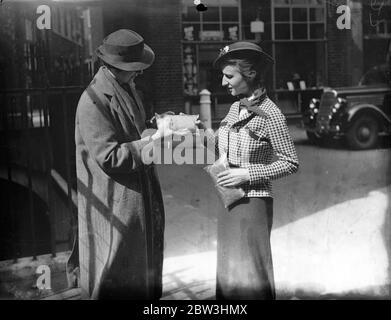 Girls ' Two - Ounce Water - Proofs That Fold Into Envelopes . A party of American girls from Chicago have introduced a new invisible fashion to London during a European tour . It is waterproof cape completely transparent and weighing only two ounces . The cape is 10 per cent . rubber and when not in use folds into an envelope six inch by four . It costs about four shillings and provides covering from head to foot . Photo shows : The capes folded into envelopes . 13 Jul 1936 Stock Photo