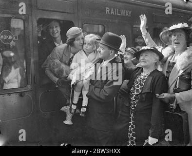 British women athletes leave for Olympic Games . The girl athletes forming Britain ' s woman ' s team for the Olympic Games , left Victoria Station , London , for Berlin where the 1936 Games open next week . The team includes Civil Servants , an artist , two schoolgirls and University students , and is led by Mrs Cornell , the manager , Mrs Cornell , Hon Secretary of the Women ' s AAA . Photo shows , Mrs Cornell , the manager of the team , kissing her baby daughter Lorna . 30 July 1936 Stock Photo