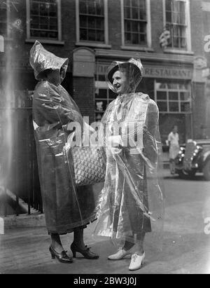 Invisible  Protection Against English Summer - American Girls Introduce New Fashion To London A party of American girls from Chicago have introduced a new invisible fashion to London during a European tour . It is waterproof cape completely transparent and weighing only two ounces . The cape is 10 per cent . rubber and when not in use folds into an envelope six inch by four . It costs about four shillings and provides covering from head to foot . Photo shows : The girls wearing their transparent capes as they inspected Dr . Johnson ' s house in the City . 13 Jul 1936 Stock Photo