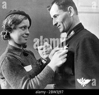 Order of the Red Star for Soviet Air Squadron Commander Trenchika , presented by Muza Malinovsky , famous woman parachutist , in Moscow . 8 December 1935 Stock Photo