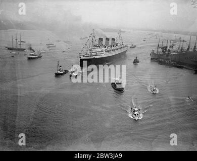 ' RMS Queen Mary ' sails from Southampton on maiden voyage . Cheered by a quarter of a million people filling every available inch of the dockes . ' Queen Mary ' , 80 , 000 ton pride of the British Merchant Navy , sailed from Southampton on her maiden voyage to America . She was ' dressed over all ' with flags and hundreds of boats scurried around her as she moved away . Photo shows , an aerial view of the ' RMS Queen Mary ' , leaving Southampton docks . 27 May 1936 Stock Photo