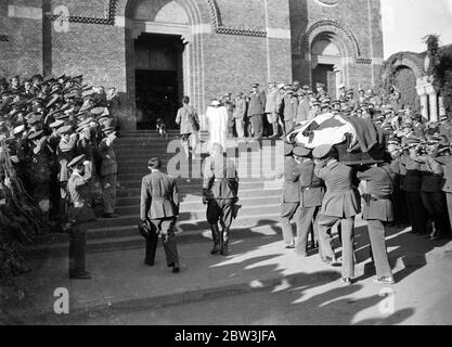 First airman killed in Abyssinian war given military funeral . The first airman killed in the Abyssinian war , Sergeant Birngo Dalmazio , a 24 year old flight sergeant and mechanic of the Italian forces who was wounded while on a bombing raid , was buried with full military honours in Asmara . Dalmazio , , who was hit by a dum dum bullet while flying with Lieutenant Sanze on a bombing raid on a decoy native camp in the valley between Enda Micael and Buja , was taken to hospital at Asmara but died from his wounds . Photo shows , the body of Sergeant Brirago Dalmazi being carried by comrades int Stock Photo