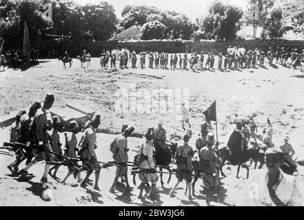 Askari troops with flags serving under the Italian colonial powers . Pictures of the Abyssinian campaign by Ray Rousseau , Planet News staff photographer from Paris bureau. 27 November 1935 Stock Photo