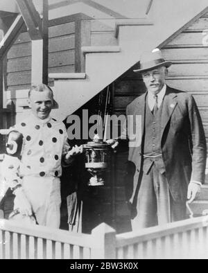 William A Woodward owner of Gallout Fox with the trophy and Earl Sanole , America ' s Premier jockey as they left the judges stand with the cup presented to them as token of winning the Arlington Classic at Chicago . 1936 Stock Photo
