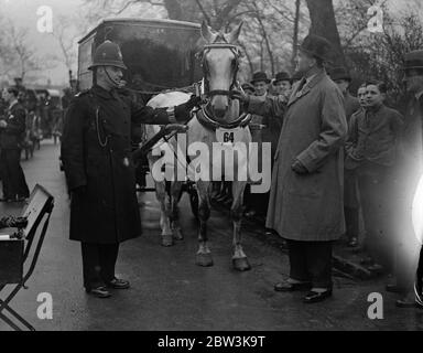 Easter Monday van horse paradein Regent ' s Park . The Easter Monday van horse parade organised by the London Van Horse Parade Society was held in the Inner Circle , Regent ; s Park . This was the 28 annual show . Photo shows , Lieutebebt Colonel Sir Percy Laurie judging an entry . 13 April 1936 Stock Photo