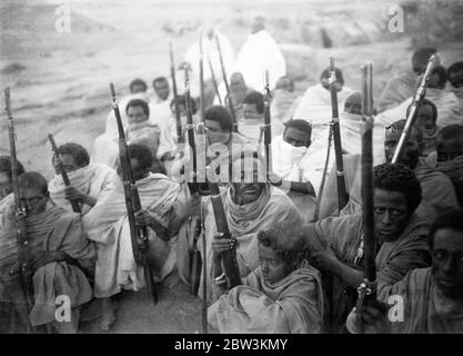 Natives who surrendered to Italian troops get to keep their rifles . Pictures of the Abyssinian campaign by Ray Rousseau , Planet News staff photographer from Paris bureau. 27 November 1935 Stock Photo