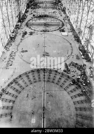 Germany starts work on airship to beat the ' Hindenburg ' . Work has started at the Friedrichshafen zeppelin building center , on LZ 130 , an airship which will be greater and finer than even LZ129 , the Hindenburg . The skeleton of the new airship is at present being constructed . Photo shows , a general view of work on the new airship at Freiedrichshafen . . 4 June 1936 Stock Photo