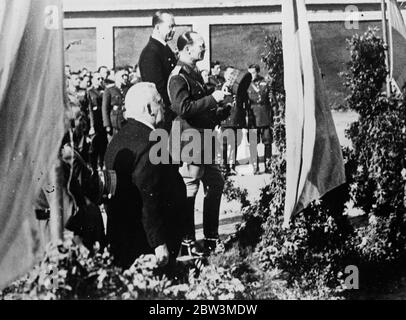 King George of Greece at first public ceremony since restoration to throne . King George saluting the flag of the regiment . Left of the King is Crown Prince Paul , the King 's brother , and right is M Domerdzis , the succeeded General Kondylis as Premier . 9 December 1935 Stock Photo