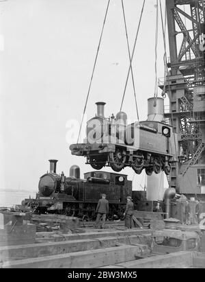 Loading two railways engines by the 150 ton floating crane for the Isle of Wight holiday rush . Southern Railway , trains . 1936 Stock Photo