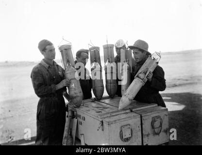 Loading bombs for Count Ciano to drop . Italian Northern Front . Aerial bombs ready to be loaded on machines of the Desperate Squadron . 18 December 1935 Stock Photo