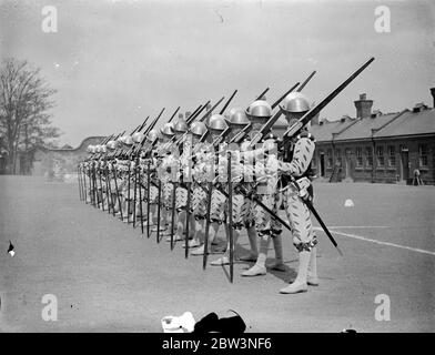 Norfolk regiment ' Musketeers ' rehearse for Royal Tournament . The 2nd Battalion , the Royal Norfolk Regiment , held a full rehearsal at Aldershot for the pageant which will be a feature of the Royal Tournament at Olympia . Photo shows , ' Musketeers ' of the Elizabethan period drilling . 30 April 1936 . Stock Photo