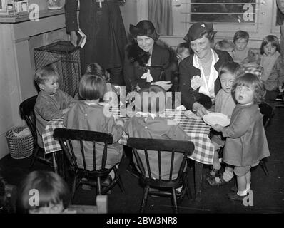 Lady Astor opens first nursery school in Camberwell . The first nursery school in Camberwell , at the Stafford Street Settlement , Peckham , which is run by the Union of Girls Schools , was opened by Lady Astor . Photo shows , Lady May Abel Smith with Lady Astor , MP ( right ) taking tea with the children at the Nursery School . 10 December 1935 Stock Photo
