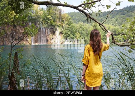 Woman enjoying view of waterfalls and lakes in Plitvice National Park, Croatia Stock Photo