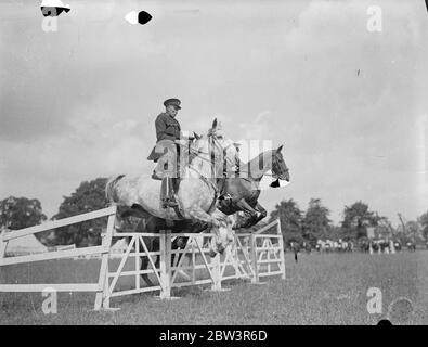 Police riders compete at Imber Court horse show . The Metropolitan Police Horse Show , in which crack police riders from all over the counrty are competing has opened at Imber Court , Twickenham , Middlesex . The show , the sixteenth , is the last at which the man who started it , Lieutenant Colonel , Sir Percy Laurie , Assistant Commisioner , attends in his official capacity , as he retires next week . Photo shows , No 1 section competing in the half section jumping . 8 July 1936 Stock Photo